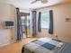 Bedroom with a sliding glass door to a patio and gray curtains at 3001 58Th S Ave # 312, St Petersburg, FL 33712