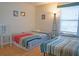 Bright bedroom featuring two twin beds, neutral walls, and light wood flooring at 3001 58Th S Ave # 312, St Petersburg, FL 33712