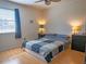 Comfortable bedroom with a queen bed, a ceiling fan and warm lighting at 3001 58Th S Ave # 312, St Petersburg, FL 33712