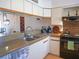 Well-maintained kitchen with stainless steel sink, tile backsplash, and efficient appliances at 3001 58Th S Ave # 312, St Petersburg, FL 33712