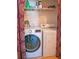 A conveniently located laundry room with a full-size washer and dryer behind a decorative curtain at 3001 58Th S Ave # 312, St Petersburg, FL 33712