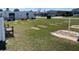 Outdoor horseshoe pit area with seating and shade, perfect for community recreation and leisure at 36416 Cordova Cir, Zephyrhills, FL 33541