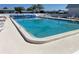 Inviting community pool with ample lounge chairs for relaxing poolside in a well-maintained area at 36416 Cordova Cir, Zephyrhills, FL 33541