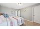 Cozy bedroom with a white dresser, light gray walls, and carpet flooring at 4515 Bent Tree Blvd, Sarasota, FL 34241