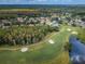 Aerial view of a golf course community featuring lush greenery, ponds, and well-maintained homes at 4906 Turtle Creek Trl, Oldsmar, FL 34677