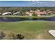 Aerial view of the neighborhood on the water, featuring a beautiful lake and lush green golf course at 4906 Turtle Creek Trl, Oldsmar, FL 34677