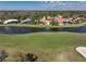 Aerial view of the property's position on a golf course and scenic lake at 4906 Turtle Creek Trl, Oldsmar, FL 34677