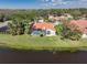 Waterfront home with a screened in pool and expansive backyard with lush landscaping at 4906 Turtle Creek Trl, Oldsmar, FL 34677