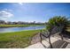 Scenic backyard view showcasing a tranquil pond and well-maintained landscaping at 4906 Turtle Creek Trl, Oldsmar, FL 34677
