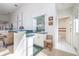 Convenient bar area featuring glass shelving, stylish decor, and a view into the restroom at 4906 Turtle Creek Trl, Oldsmar, FL 34677