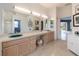 A luxurious bathroom featuring a large double vanity with plenty of room and natural light at 4906 Turtle Creek Trl, Oldsmar, FL 34677