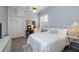 Bright, cozy bedroom features white furnishings, a ceiling fan, and wood-look flooring at 4906 Turtle Creek Trl, Oldsmar, FL 34677