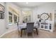Sunlit breakfast nook with a view of the pool area, comfortable seating, and stylish decor at 4906 Turtle Creek Trl, Oldsmar, FL 34677