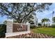 Ardea Country Club entrance sign with beautiful landscaping and building on a sunny day at 4906 Turtle Creek Trl, Oldsmar, FL 34677