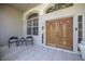 Grand entrance featuring double doors, transom window and tile floor at 4906 Turtle Creek Trl, Oldsmar, FL 34677