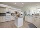 Bright kitchen with white cabinets, modern appliances, and a center island for food preparation at 4906 Turtle Creek Trl, Oldsmar, FL 34677