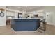 Modern kitchen with granite countertops, stainless steel appliances, and contrasting blue island at 4906 Turtle Creek Trl, Oldsmar, FL 34677