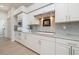 Updated kitchen features white cabinets, countertops, modern appliances, and a sleek design at 4906 Turtle Creek Trl, Oldsmar, FL 34677