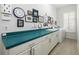 A well-lit laundry room with a long counter, cabinets, washer, and dryer at 4906 Turtle Creek Trl, Oldsmar, FL 34677