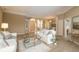 Well-lit living area showcases neutral tones, glass coffee table, and entryways to other rooms at 4906 Turtle Creek Trl, Oldsmar, FL 34677