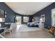 Spacious main bedroom with dark blue accent wall, ceiling fan, and light wood-look flooring at 4906 Turtle Creek Trl, Oldsmar, FL 34677