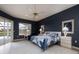 This bedroom features a ceiling fan, blue accent wall, and access to the outdoor pool area at 4906 Turtle Creek Trl, Oldsmar, FL 34677