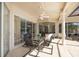 Covered patio featuring a dining set perfect for outdoor entertainment at 4906 Turtle Creek Trl, Oldsmar, FL 34677