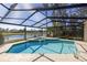 Relaxing screened-in pool area with spa and seating overlooking a serene lake at 4906 Turtle Creek Trl, Oldsmar, FL 34677