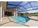 Sparkling pool and spa surrounded by a screened enclosure and patio at 4906 Turtle Creek Trl, Oldsmar, FL 34677