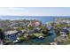 Breathtaking aerial view of waterfront homes along a canal leading to a scenic bay at 4907 W Spring Lake Dr, Tampa, FL 33629