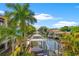 Stunning aerial view showcases the home's waterfront location and boat dock at 4911 W Melrose S Ave, Tampa, FL 33629
