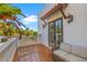 Balcony with terracotta tiles, outdoor seating, stucco walls, and view of palm trees at 4911 W Melrose S Ave, Tampa, FL 33629
