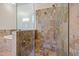 This elegant bathroom features a glass shower and a soaking tub with gold hardware at 4911 W Melrose S Ave, Tampa, FL 33629
