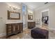 This bathroom features a walk-in closet, double vanities, and elegant lighting fixtures at 4911 W Melrose S Ave, Tampa, FL 33629