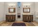 A well-lit bathroom features double vanities with decorative mirrors and an accent stool at 4911 W Melrose S Ave, Tampa, FL 33629