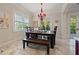 Charming dining area with a rustic table, bench seating, and a decorative chandelier at 4911 W Melrose S Ave, Tampa, FL 33629