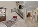 Grand foyer featuring a staircase with iron railings, beautiful tile floors, and ample natural light at 4911 W Melrose S Ave, Tampa, FL 33629