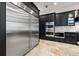 Spacious kitchen with stainless steel refrigerator and appliances complemented by stylish black cabinetry at 4911 W Melrose S Ave, Tampa, FL 33629