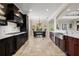 Open kitchen featuring black cabinetry, marble countertops, and stainless steel appliances at 4911 W Melrose S Ave, Tampa, FL 33629