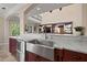 Open kitchen view showcasing a stainless steel farmhouse sink and marble countertops at 4911 W Melrose S Ave, Tampa, FL 33629