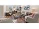 Well-lit living room with decorative rug, comfortable seating, and bright windows at 4911 W Melrose S Ave, Tampa, FL 33629