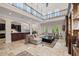 Expansive living space featuring a soaring ceiling, a second-story balcony, and access to a gourmet kitchen at 4911 W Melrose S Ave, Tampa, FL 33629