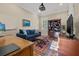 Cozy home office with a comfortable blue couch, built-in bookcase, and ample natural light at 4911 W Melrose S Ave, Tampa, FL 33629