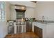 Outdoor kitchen with stainless steel appliances and granite countertops, perfect for entertaining at 4911 W Melrose S Ave, Tampa, FL 33629