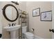 Charming powder room features pedestal sink and decorative mirror at 4911 W Melrose S Ave, Tampa, FL 33629