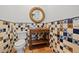 Charming powder room with tile accents, decorative mirror, and rustic vanity at 4911 W Melrose S Ave, Tampa, FL 33629