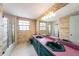 The bathroom features a large vanity, a double sink, tile walls, and a shower at 5105 W Cleveland St, Tampa, FL 33609