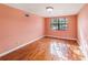 Empty bedroom with hardwood floors and window for natural light at 5105 W Cleveland St, Tampa, FL 33609