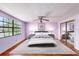 Staged bedroom with bed, ceiling fan, and sliding closet door at 5105 W Cleveland St, Tampa, FL 33609