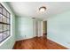 Bright bedroom features hardwood floors, natural light from window, and closet at 5105 W Cleveland St, Tampa, FL 33609